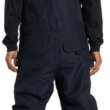 DC Shadow Shell Bib Pants 2024 - Black snow pants with a subtle white stripe on the side of each leg.