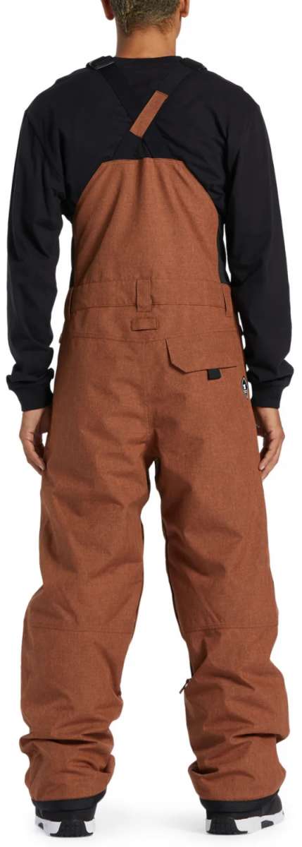DC Shadow Shell Bib Pants 2024 - A pair of brown snowboard pants with a black logo on the left leg and a zippered pocket on the right thigh.