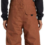 DC Shadow Shell Bib Pants 2024 - A pair of brown snowboard pants with a black logo on the left leg and a zippered pocket on the right thigh.