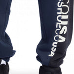 DC Static Sweatpants 2024 - Pair of navy blue sweatpants with white lettering down one leg.