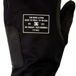 DC Tribute Mitt 2023 - Black mittens with a textured pattern on the palm side, featuring a white DC logo on the back of one mitten.