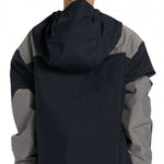 DC Youth 43 Insulated Anorak Jacket 2024 - A black, grey and white jacket with a hood on a young model wearing it from behind.