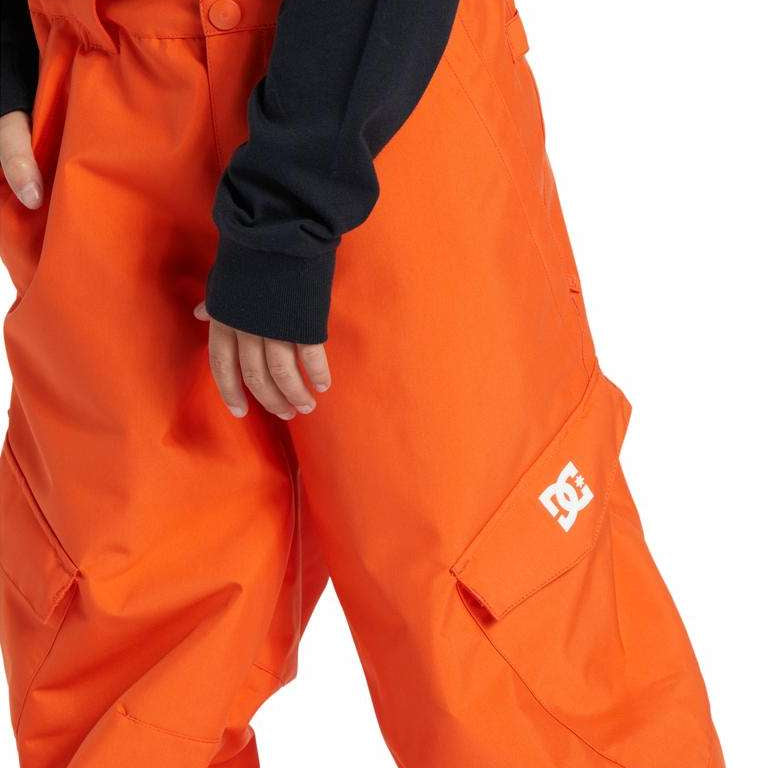 DC Youth Banshee Insulated Pant 2024 - A pair of bright orange snow pants with a white logo on the left leg, featuring two pockets and a button fly closure.