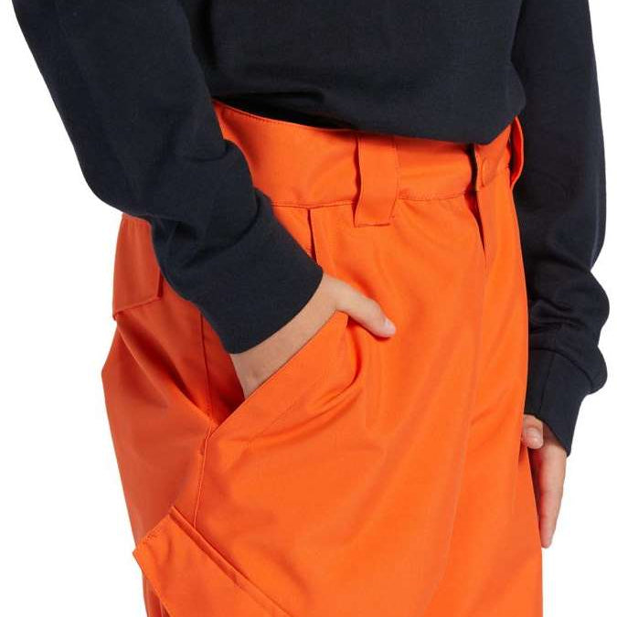 DC Youth Banshee Insulated Pant 2024 - A pair of orange snow pants with a white DC logo on the left thigh and a black strap with a silver buckle at the waist.
