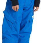 DC Youth Banshee Insulated Pant 2024 - A pair of blue snow pants with a white logo on the left leg, featuring two front pockets and a button fly closure.