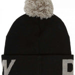 DC Youth Gambol Beanie 2024 - A black beanie with a white logo on the front and a large, fluffy pom-pom on top.