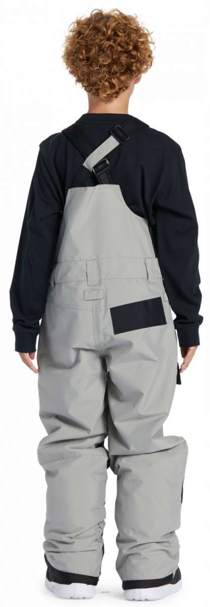 DC Youth Roadblock Insulated Bib 2024 - A pair of gray snow pants with a black strap on the back and a small pocket on the right side.