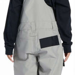 DC Youth Roadblock Insulated Bib 2024 - A pair of gray snow pants with a black strap on the back and a small pocket on the right side.