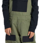 DC Youth Roadblock Insulated Bib 2024 - A pair of olive green snow pants with black accents and a white DC logo on the left leg.