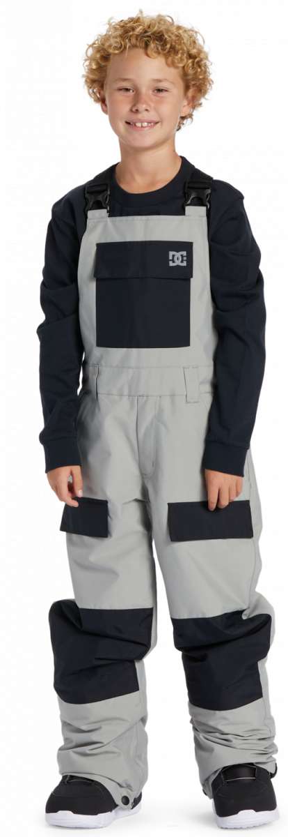 DC Youth Roadblock Insulated Bib 2024 - A pair of gray snow pants with black accents and a white logo on the left thigh.