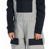 DC Youth Roadblock Insulated Bib 2024 - A pair of gray snow pants with black accents and a white logo on the left thigh.