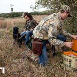 Yeti Hopper Flip 18 Personal Cooler - A tan cooler with a black zipper and handle, sitting on a wooden dock near a body of water.