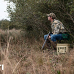 Yeti Hopper Flip 18 Personal Cooler - A tan cooler with a black handle and zipper, sitting on a wooden dock by the water.