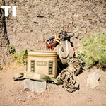 Yeti Hopper Flip 18 Personal Cooler - A tan cooler with a zipper and two handles, sitting on a wooden dock next to a body of water.