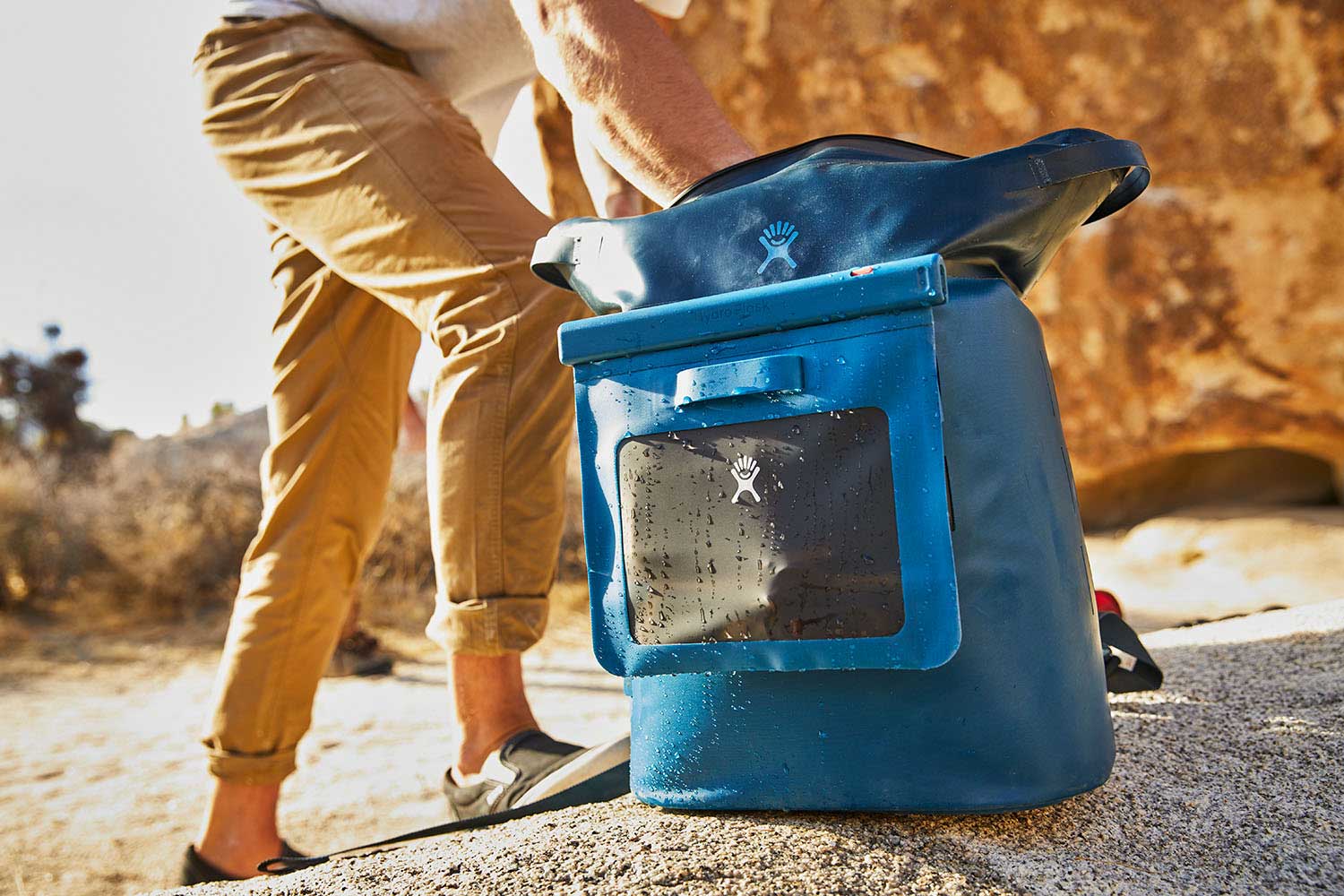 Hydro Flask Medium Dry Storage Bag - A medium-sized dry storage bag with a rectangular shape, featuring a zippered top and a handle on one side. It is primarily black in color.