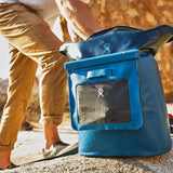 Hydro Flask Medium Dry Storage Bag - A medium-sized dry storage bag with a rectangular shape, featuring a zippered top and a handle on one side. It is primarily black in color.