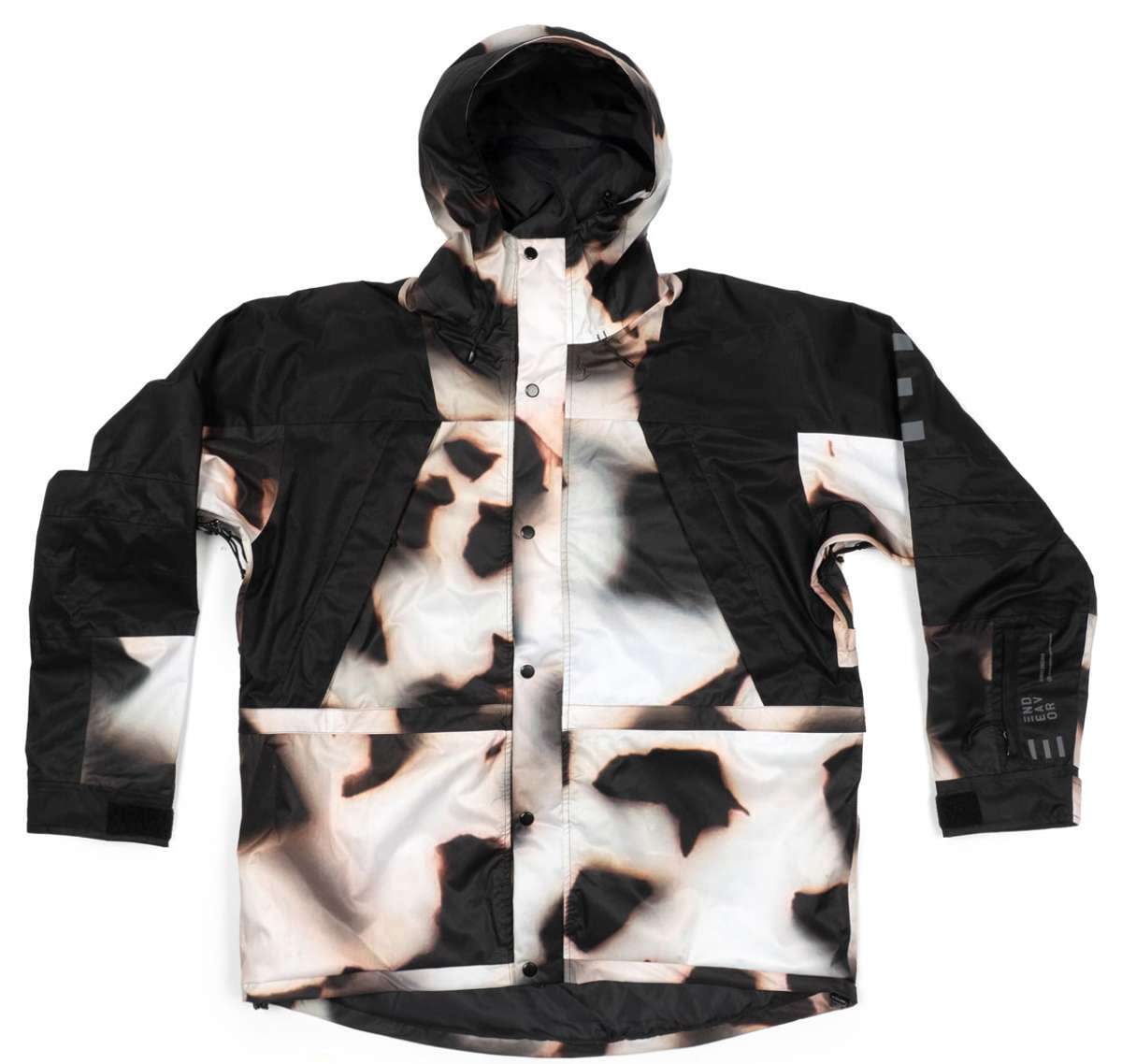 Endeavor 2 Layer Shelter Shell Jacket 2024 - A black and white jacket with a subtle leopard print pattern on the front, featuring a hood and two chest pockets.