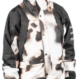 Endeavor 2 Layer Shelter Shell Jacket 2024 - A black and white jacket with a camouflage pattern, featuring a hood and two front pockets.