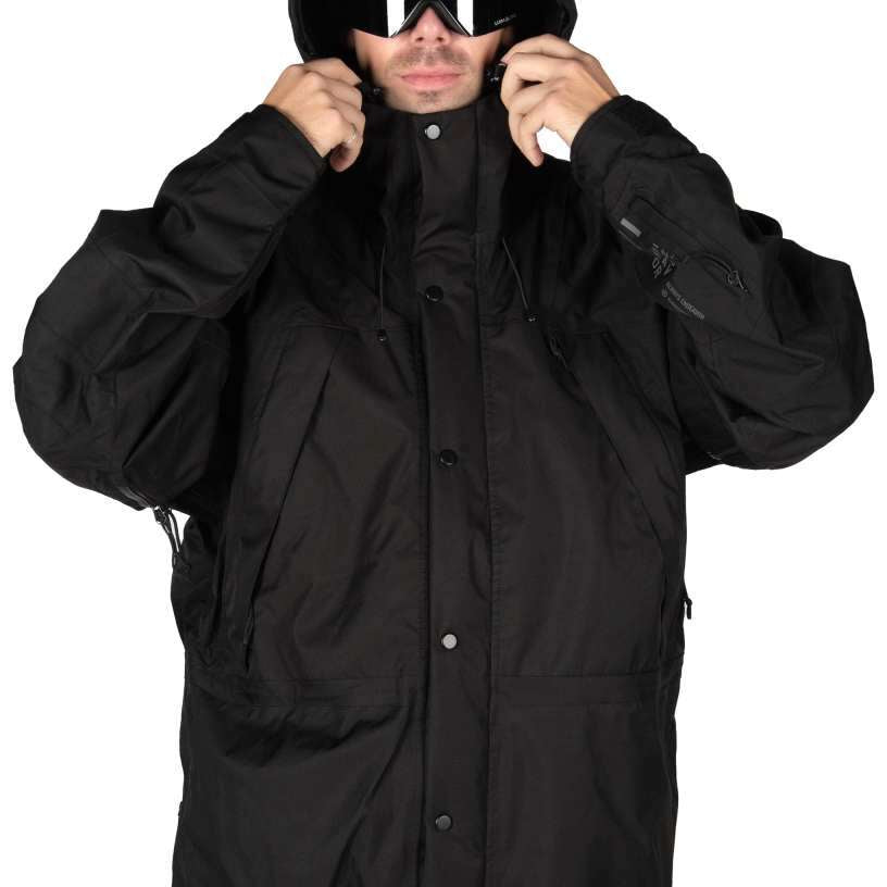 Endeavor 2 Layer Shelter Shell Jacket 2024 - A black jacket with a hood, featuring two zippered pockets on either side and a front zipper closure.