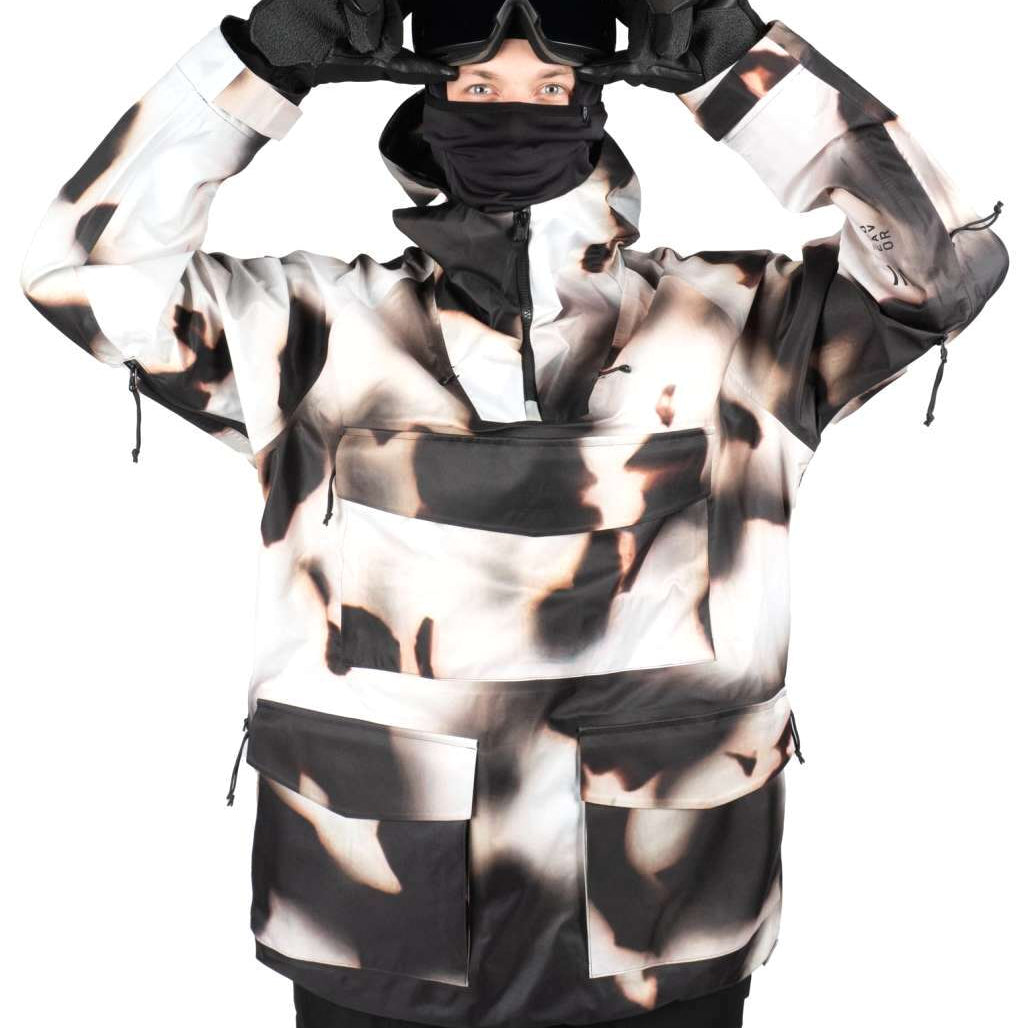 Endeavor 3 Layer Patrol Cargo Anorak - A black and white anorak with a large cargo pocket on the front, featuring a zippered chest pocket and adjustable cuffs.