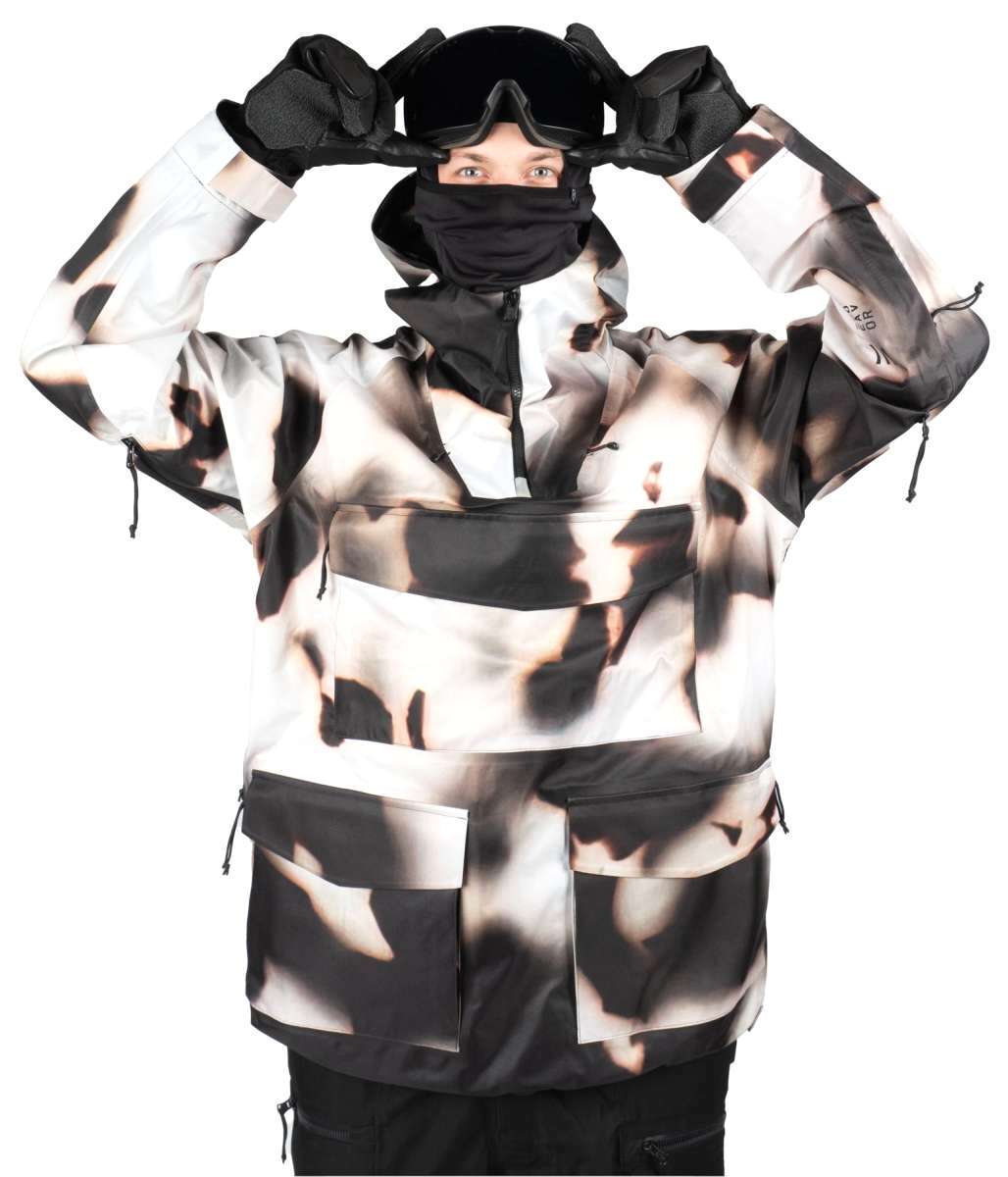 Endeavor 3 Layer Patrol Cargo Anorak - A black and white anorak with a large cargo pocket on the front, featuring a zippered chest pocket and adjustable cuffs.