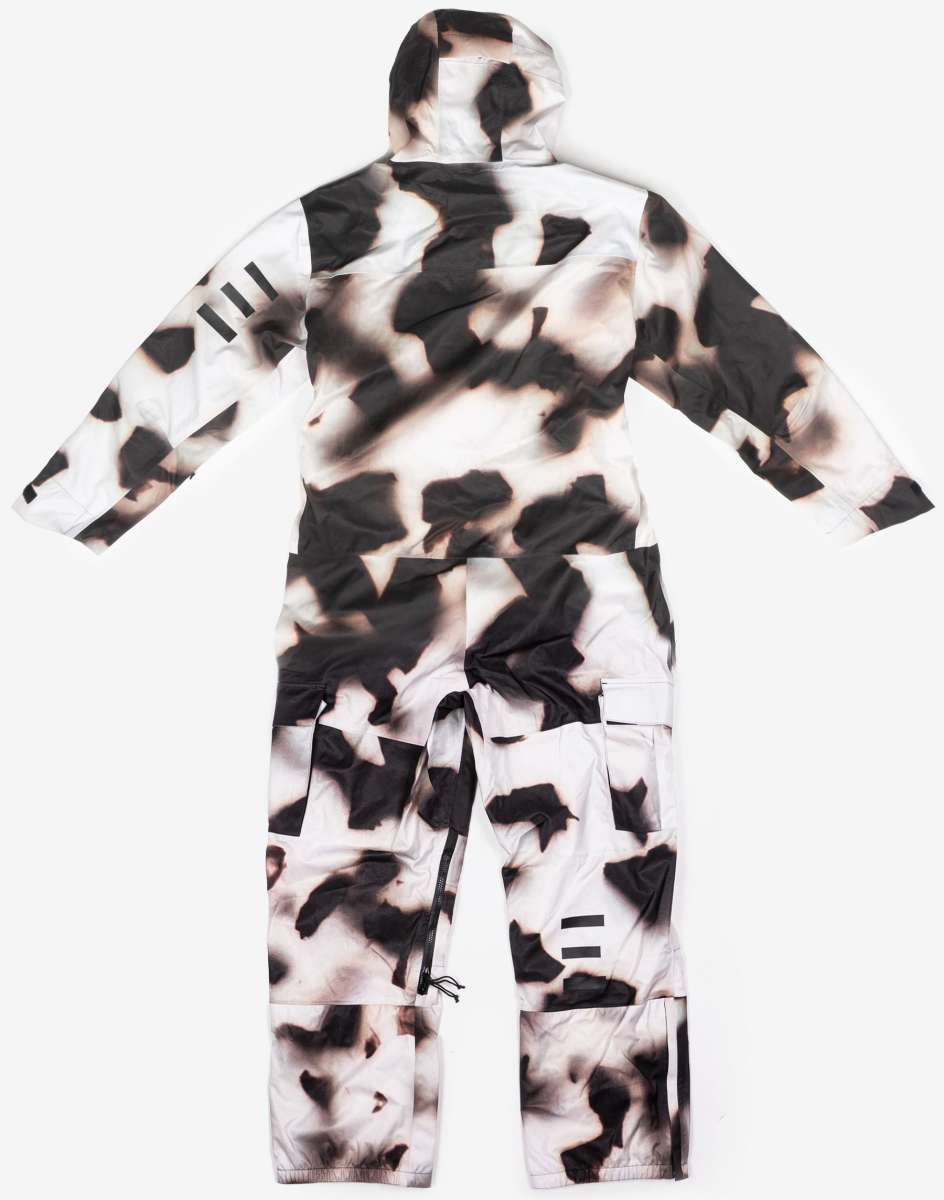 Endeavor 3L Shelter One Piece Suit 2024 - A black and white snowsuit with a cow print design, featuring a hood and zippered pockets on the front.