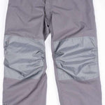 Endeavor Ranger Insulated Pant 2023 - A pair of gray insulated ski pants with a zippered pocket on each thigh and a black logo on the left leg.