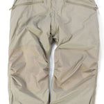 Endeavor Ranger Insulated Pant - Beige pants with a subtle sheen, featuring zippered pockets and elastic cuffs at the ankles.