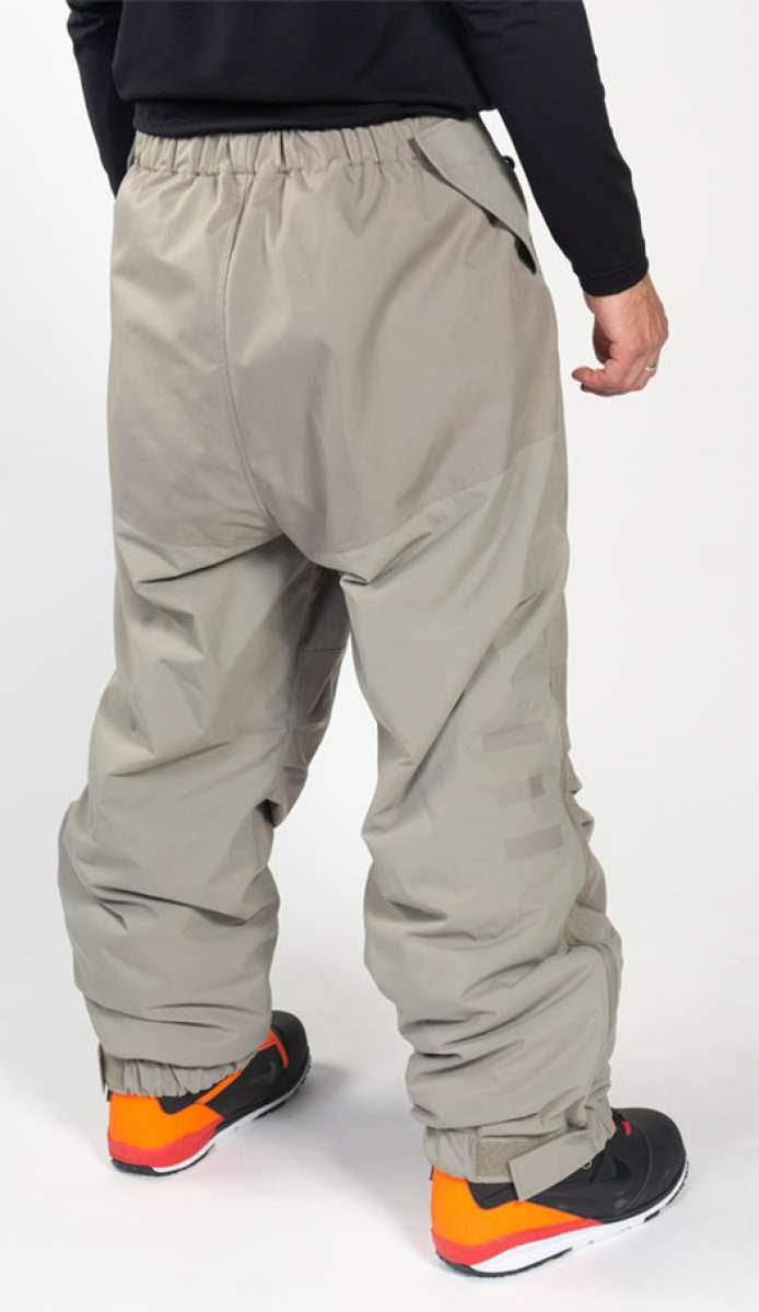 Endeavor Ranger Insulated Tall Pant - A pair of khaki-colored snow pants with a zippered pocket on the side and adjustable Velcro straps at the ankles.