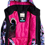 Roxy Junior's Insulated Jetty Snow Jacket 2020 - A black snow jacket with a white and pink abstract pattern, featuring a hood and zippered pockets.