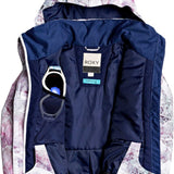 Roxy Junior's Insulated Jetty Snow Jacket 2020 - A white snow jacket with a pink and grey abstract pattern, featuring a hood and zippered pockets.