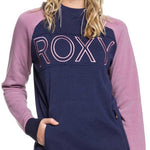 Roxy Women's Liberty Pullover Technical Hoodie 2020 - A woman with long blonde hair wearing a gray knit beanie and a navy blue hoodie with pink sleeves and "ROXY" written across the chest.