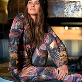 Roxy Women's Daybreak Technical Baselayer Leggings 2020 - A pair of black leggings with a palm tree print in shades of pink, orange, and white.