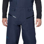 Flylow Firebird Shell Bib Pants 2024 - Dark blue bib pants with black buckles and straps, featuring a subtle white logo on the left thigh.