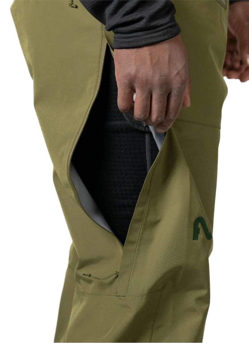 Flylow Firebird Shell Bib Pants 2024 - Olive green bib pants with a black zipper and flylow logo on the left leg.