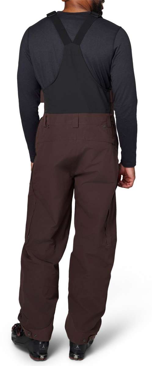 Flylow Firebird Shell Bib Pants 2024 - Black bib pants with a subtle white pattern on the front and back, featuring black suspenders and a black zipper.