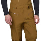 Flylow Firebird Shell Bib Pants 2024 - Black bib pants with black hardware and a subtle grid pattern on the side of the leg.