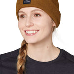 Flylow Longshoreman Beanie 2024 - A brown beanie with a black patch on the front featuring a white logo and the word "FLYLOW" in white letters.