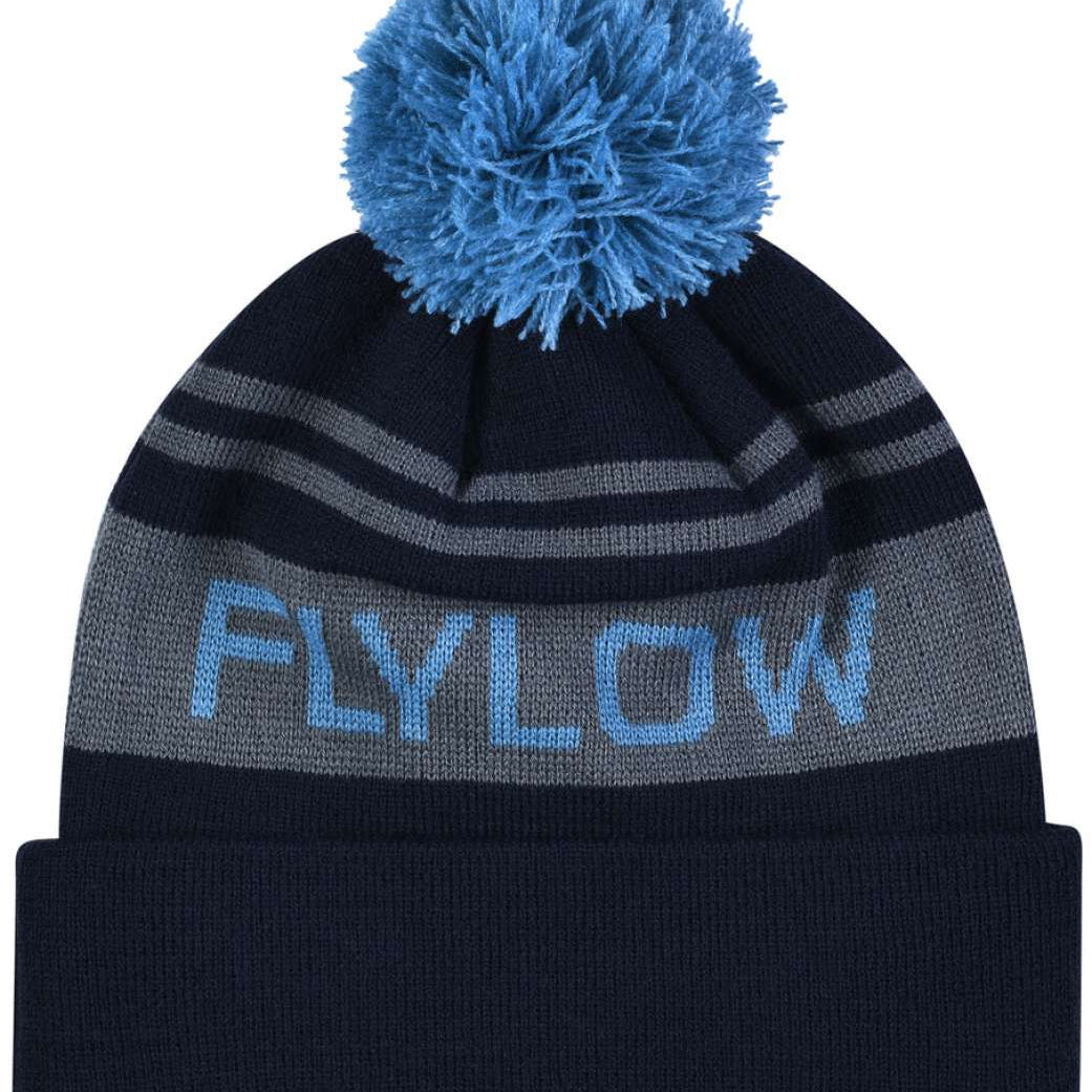 Flylow OG POM Beanie 2023 - A black beanie with a blue pom-pom on top and gray stripes around the cuff.