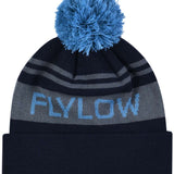 Flylow OG POM Beanie 2023 - A black beanie with a blue pom-pom on top and gray stripes around the cuff.