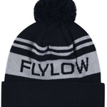 Flylow OG POM Beanie 2023 - A black beanie with a large pom-pom on top and two horizontal light gray stripes near the cuff.