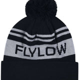 Flylow OG POM Beanie 2023 - A black beanie with a large pom-pom on top and two horizontal light gray stripes near the cuff.