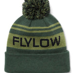 Flylow OG Pom Beanie 2024 - A green beanie with a large pom-pom on top and two horizontal stripes, one light green and one dark green.