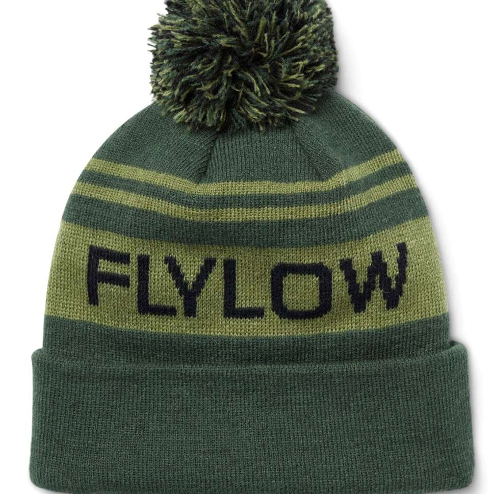 Flylow OG Pom Beanie 2024 - A green beanie with a large pom-pom on top and two horizontal stripes, one light green and one dark green.