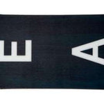 Head Daymaker Lyt Snowboard 2024 - A brown snowboard with a black stripe down the middle and white lettering on top.