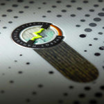 Head E Instinct LYT Snowboard 2023 - A black snowboard with a white stripe down the middle and yellow accents on the bindings.