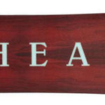 Head Gamechanger Snowboard 2024 - A dark brown snowboard with a subtle wood grain pattern and white lettering on top.