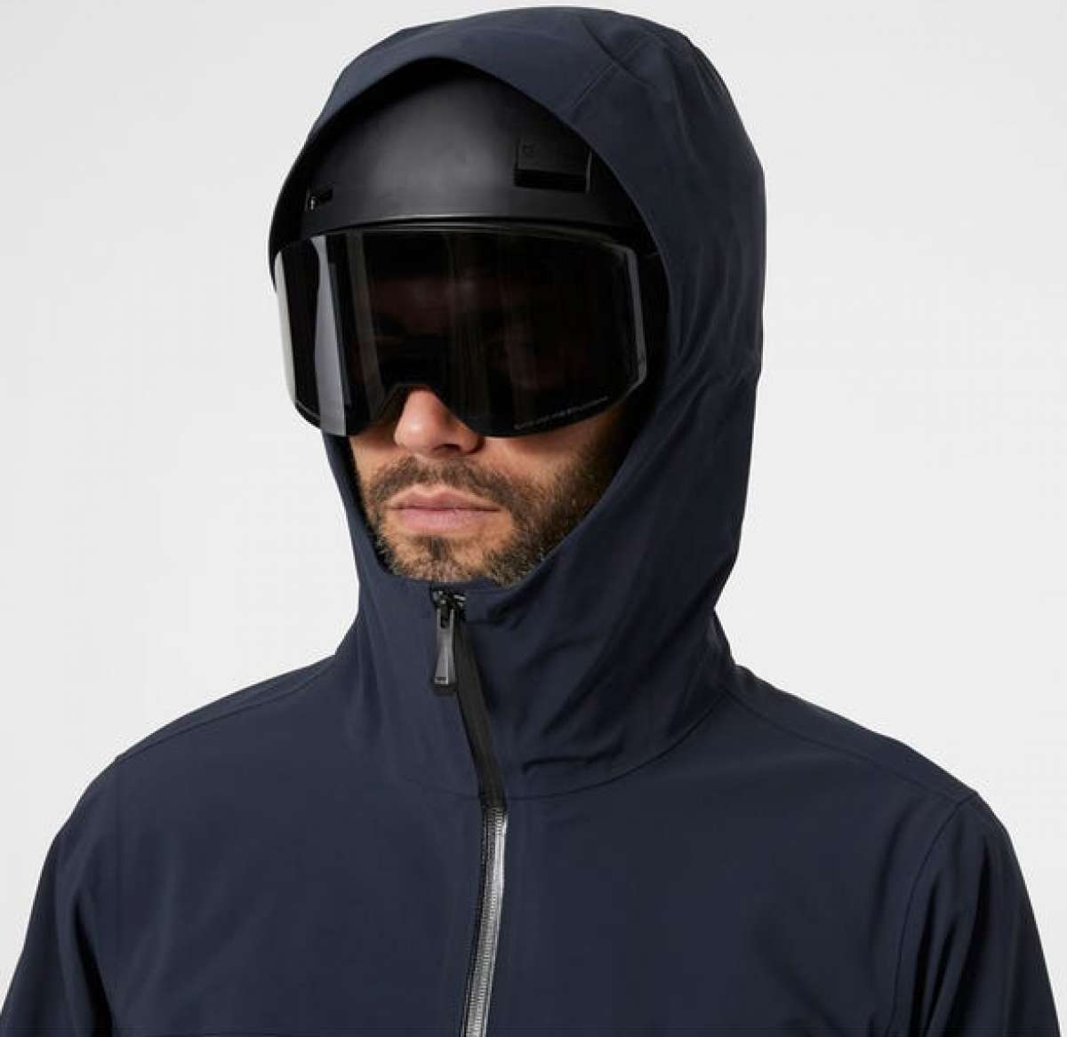 Helly Hansen - A dark blue jacket with a hood, featuring a zipper and two zippered pockets on the front.