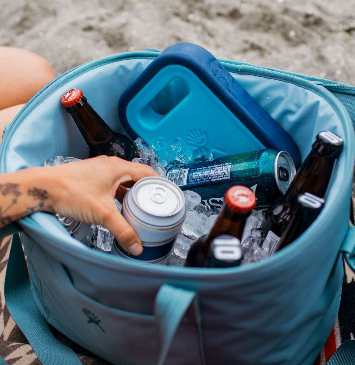 Hydro Flask - Medium blue ice pack with a circular shape, ridged edges, and a small handle on top.