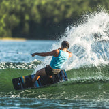 Hyperlite Women's Cadence Wakeboard 2022 - A black and blue wakeboard with a white logo on top.